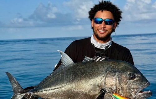 Ben Simmons holding a fish.